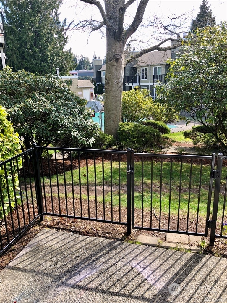 820 Cady Road, Unit B103 Everett, WA 98203 - Photo 14 of 16 a view of backyard with large trees and wooden fence