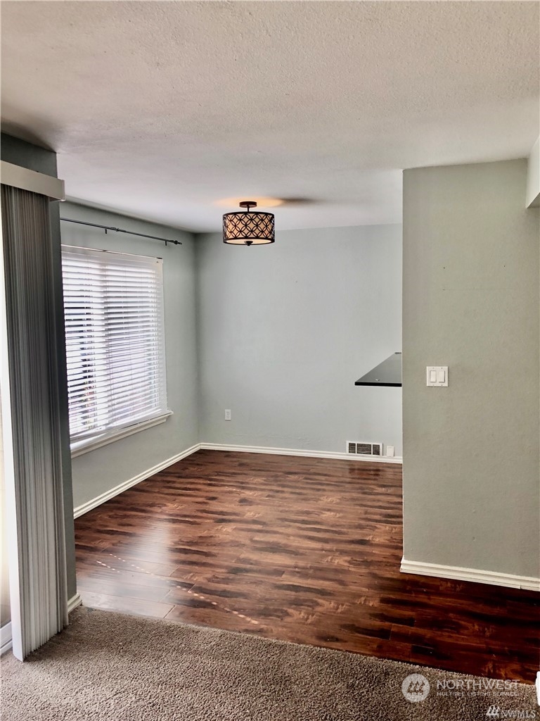 820 Cady Road, Unit B103 Everett, WA 98203 - Photo 4 of 16 a view of an empty room with wooden floor and a window