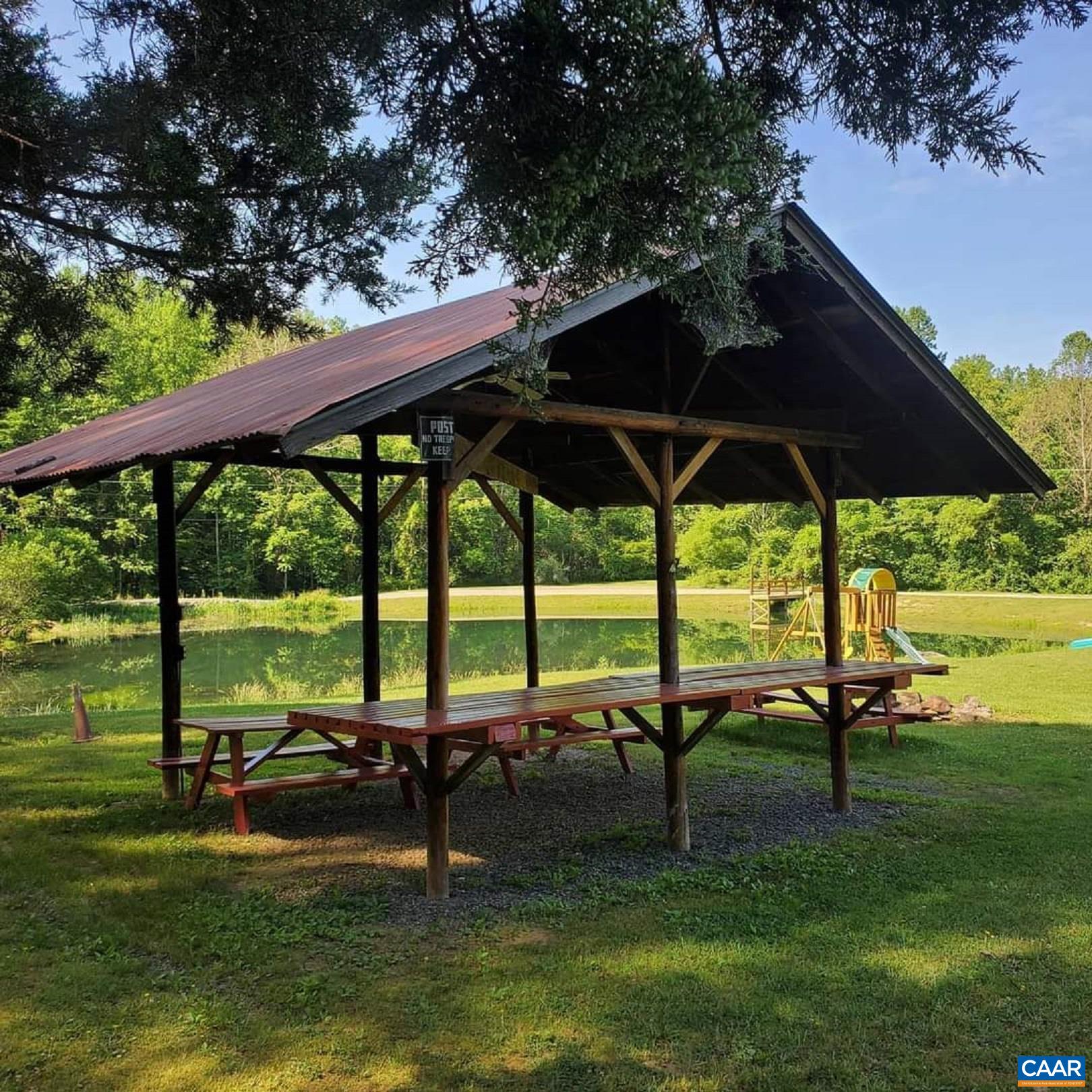 183 Circle Road Stanardsville, VA 22973 - Photo 49 of 57 a view of a swimming pool with lawn chairs under an umbrella