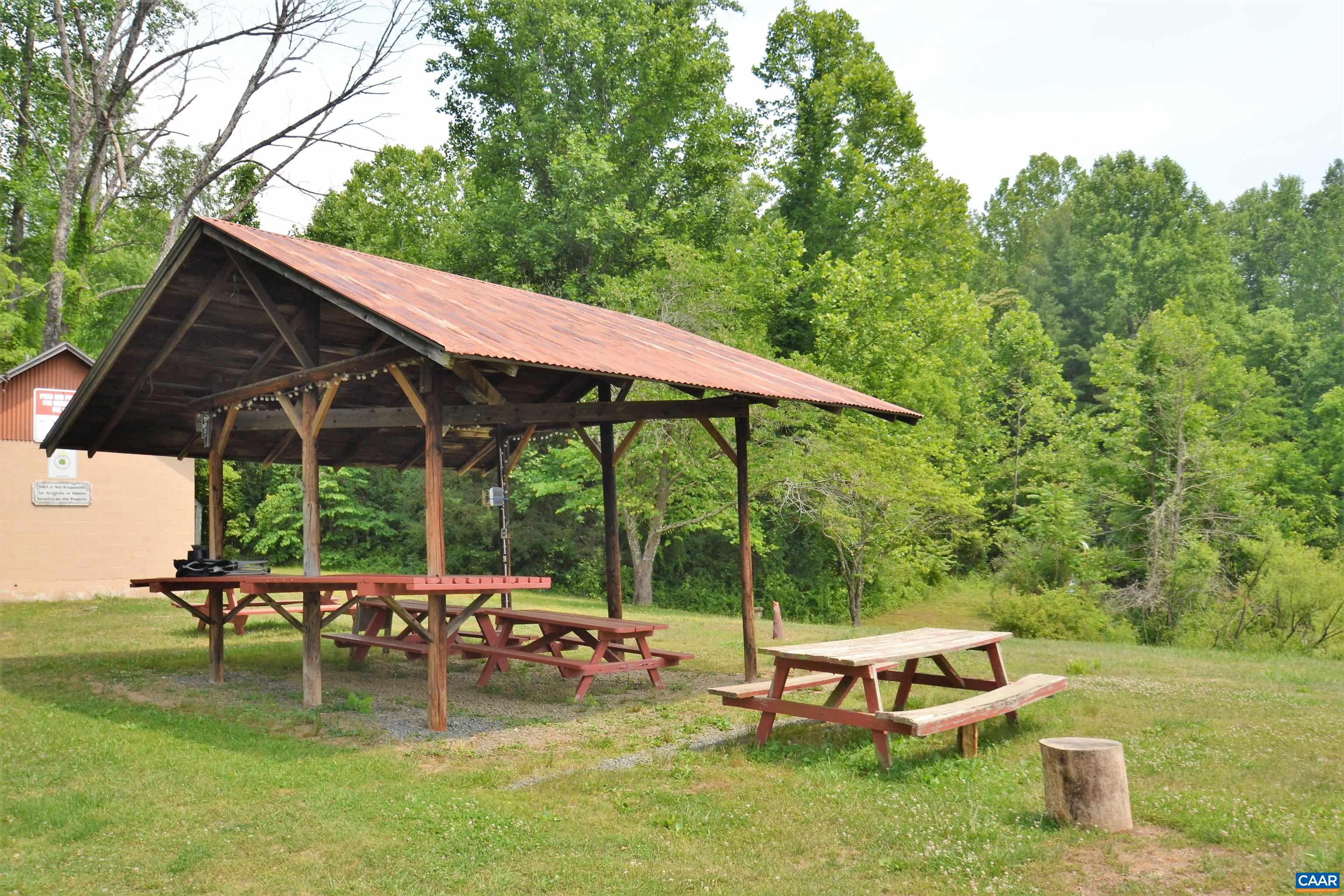 183 Circle Road Stanardsville, VA 22973 - Photo 54 of 57 a view of backyard with table and chairs under an umbrella