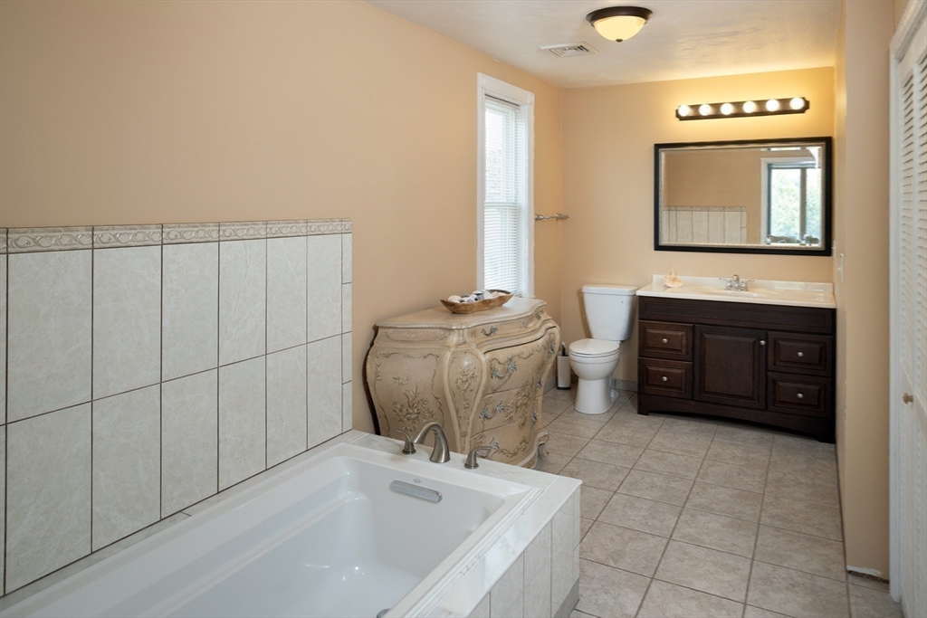 67 Newport Road Hull, MA 02045 - Photo 17 of 26 a bathroom with a sink vanity mirror and a bathtub