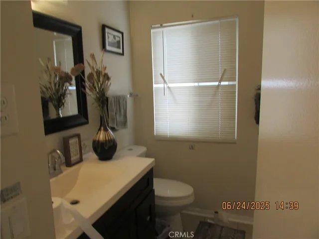 a bathroom with a sink toilet and mirror