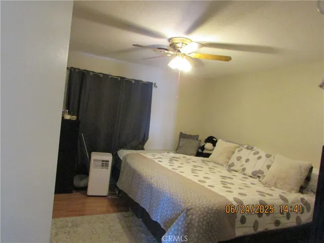 a bedroom with a bed and a mirror