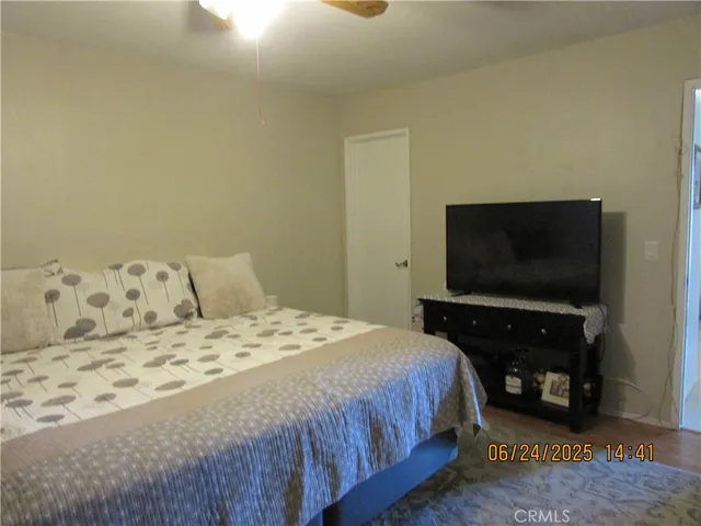 a bedroom with a bed and a flat screen tv