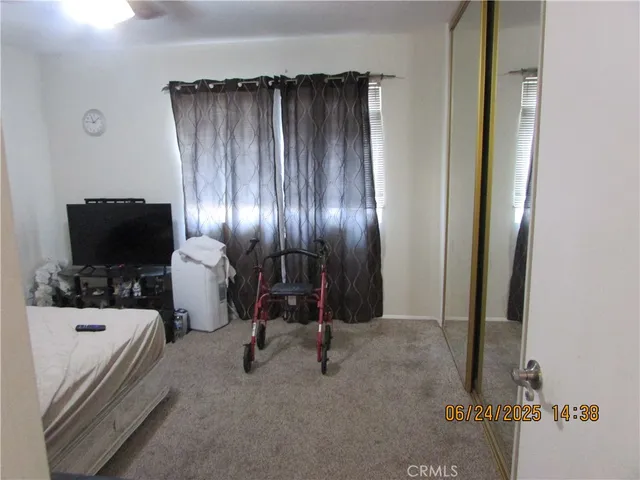 a view of a livingroom with furniture and a flat screen tv