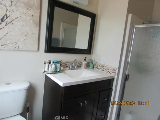 a bathroom with a sink vanity and a mirror