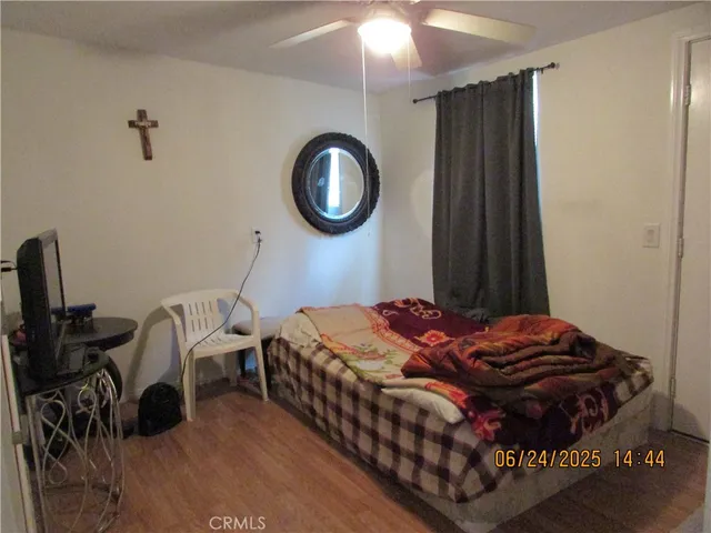 a bedroom with bed and a chandelier