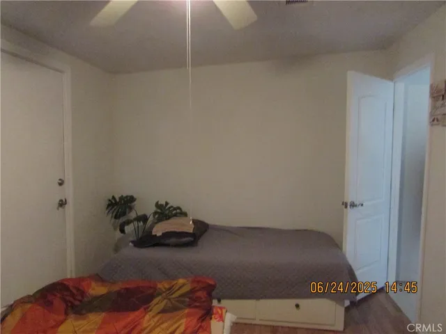 a room with a bed and wooden floor