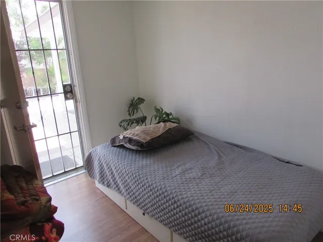 a bedroom with a bed and a large window