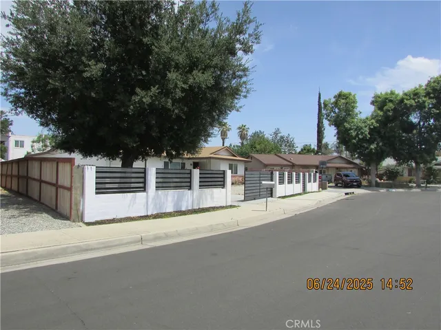 a view of a street with a cars park side of a road