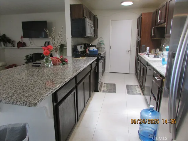 a kitchen with sink stove and cabinets
