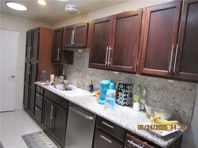 a kitchen with stainless steel appliances granite countertop wooden cabinets a sink and dishwasher