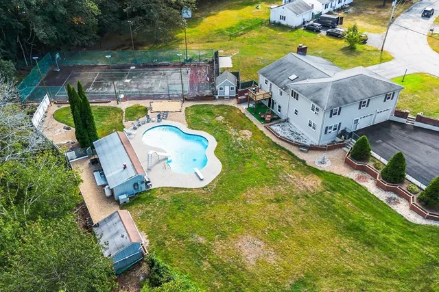 an aerial view of a house with outdoor space pool seating area and yard
