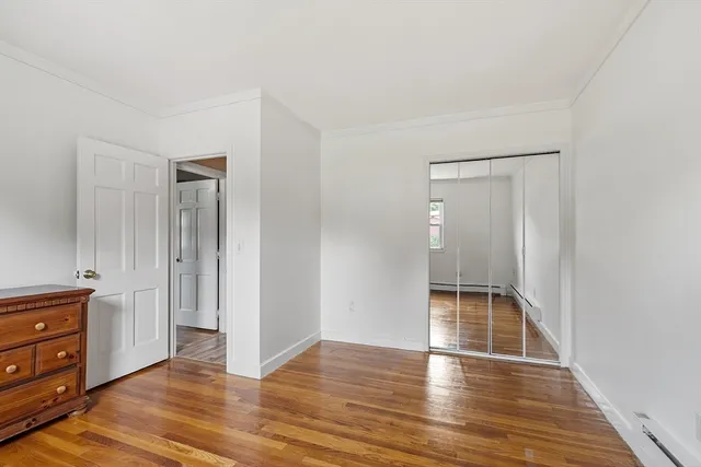 a view of a livingroom with wooden floor and furniture
