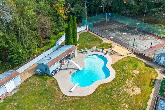 a view of a house with swimming pool and sitting area