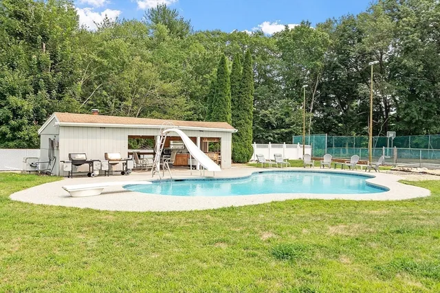 a view of a house with swimming pool and sitting area