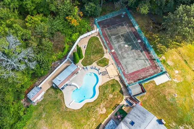 a backyard of a house with table and chairs