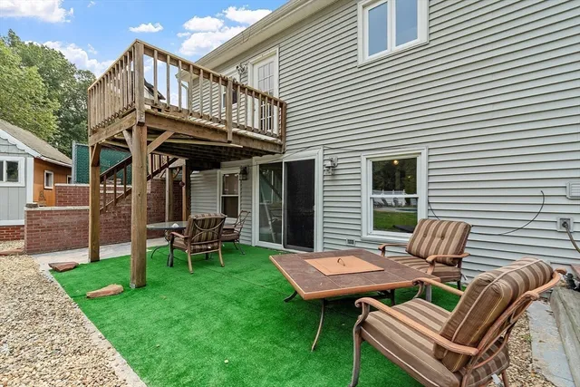an aerial view of a house with a swimming pool and outdoor seating