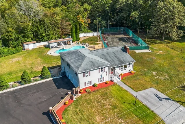 an aerial view of a house with a swimming pool
