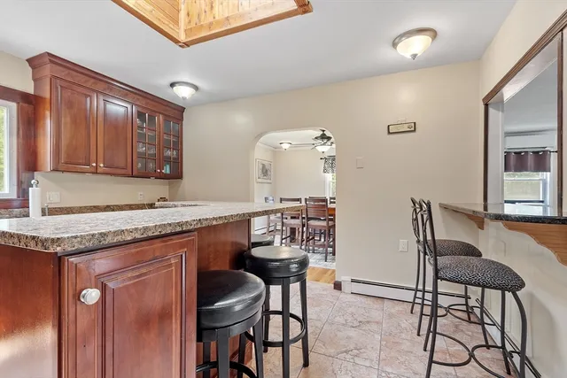 a kitchen with a table chairs sink and cabinets