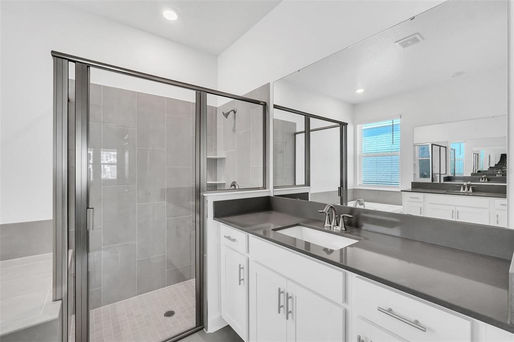 5768 Stephens Road St. Cloud, FL 34771 - Photo 28 of 50 a bathroom with a shower sink and mirror