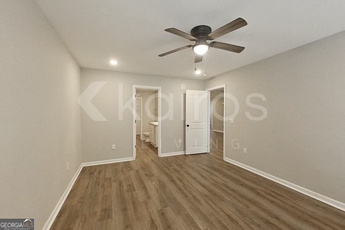 132 Cottage Grove Road Brunswick, GA 31525 - Photo 12 of 17 an empty room with wooden floor fan and windows
