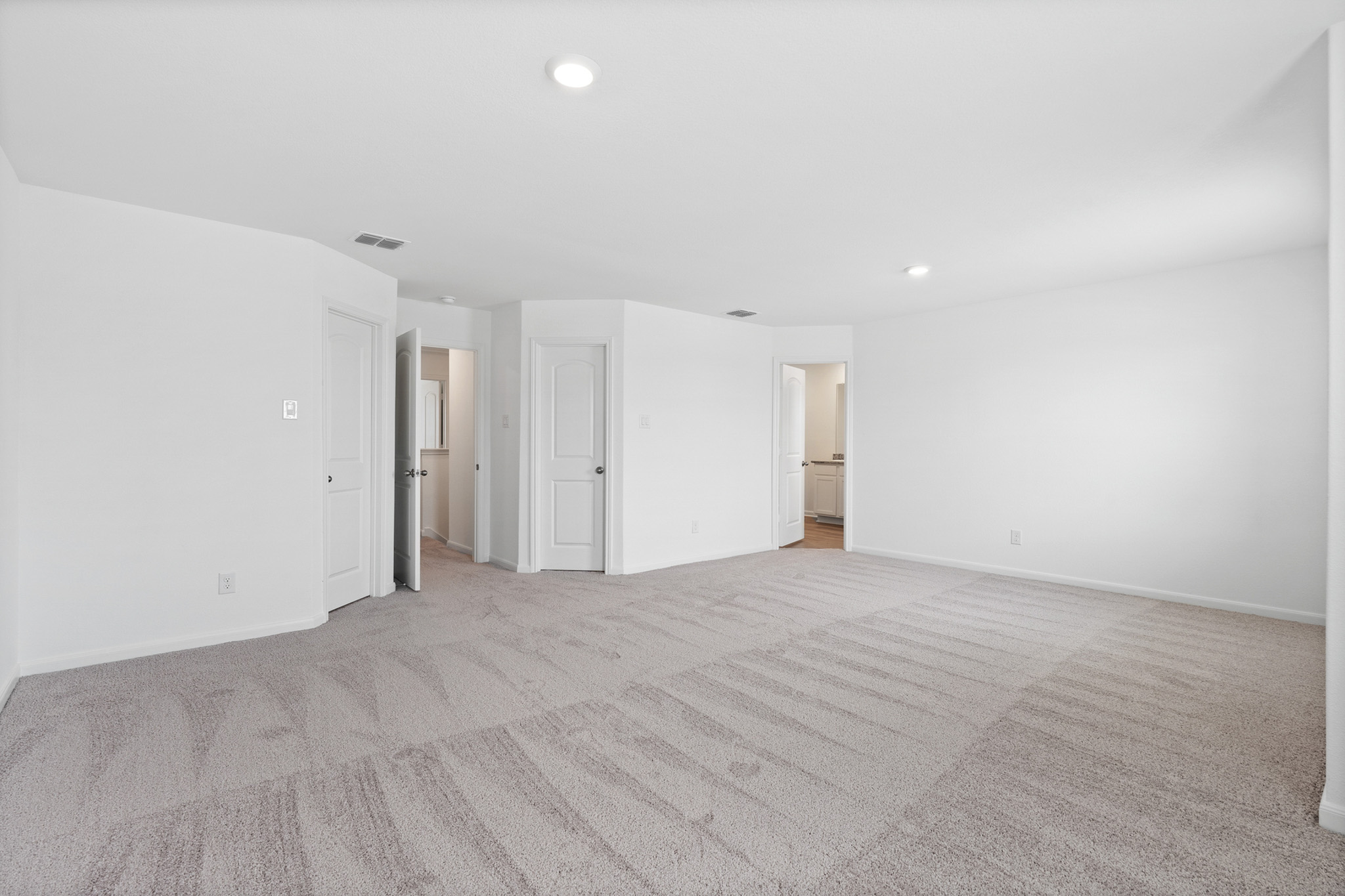 409 Silent Meadow Run Maxwell, TX 78656 - Photo 6 of 10 Unfurnished bedroom featuring light colored carpet and recessed lighting