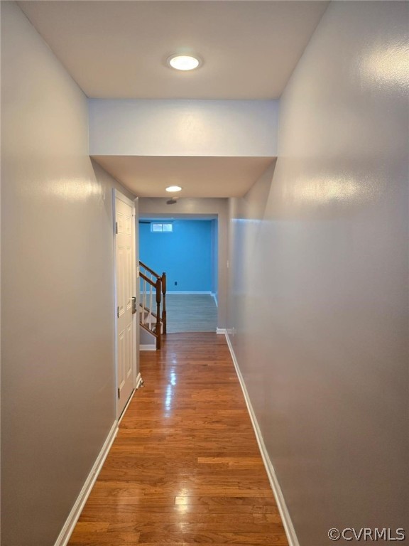 a view of a hallway with wooden floor