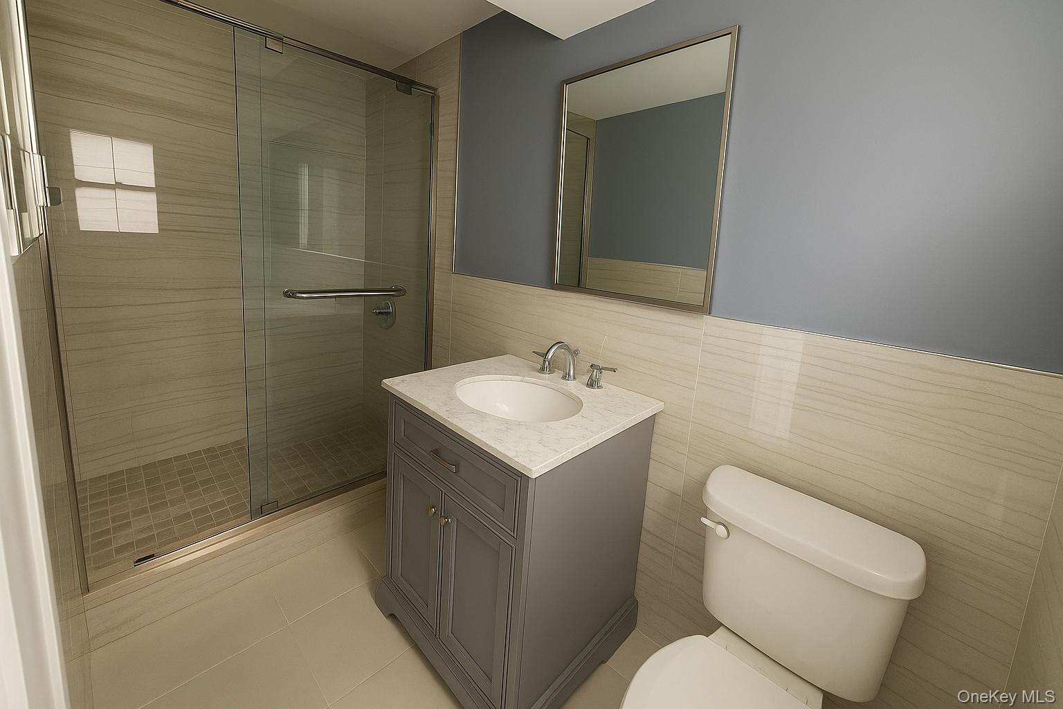 324 Buckingham Road Cedarhurst, NY 11516 - Photo 11 of 12 Full bath with a stall shower, vanity, light tile patterned floors, and tile walls