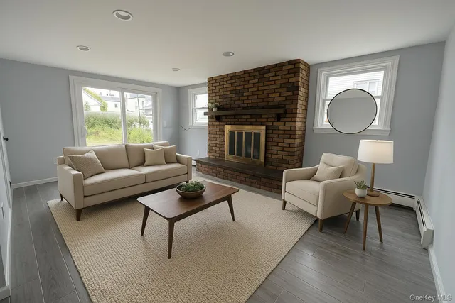 a living room with furniture wooden floor and a fireplace