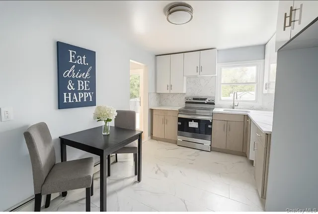a view of a workspace with furniture and window