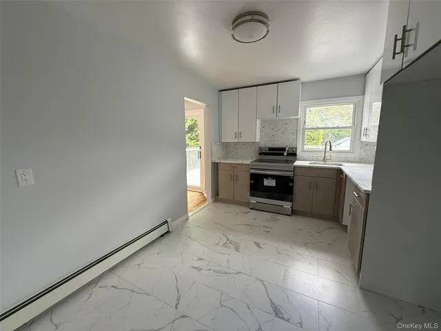 a kitchen with granite countertop a sink cabinets and appliances