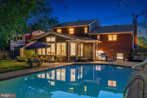 a front view of a house with a garden and sitting area