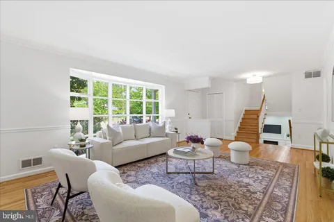 a kitchen with stainless steel appliances granite countertop a stove a sink dishwasher and a refrigerator with wooden floor