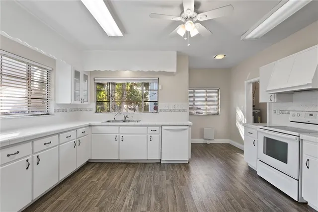 a kitchen with sink cabinets and wooden floor