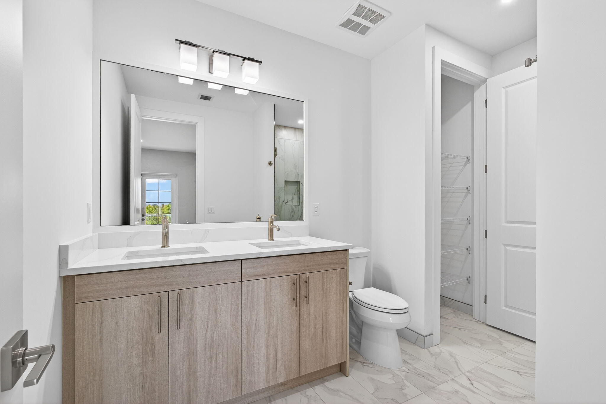 115 Water Pointe Place, Unit 35 Jupiter, FL 33477 - Photo 16 of 42 a spacious bathroom with a granite countertop sink a toilet and a mirror