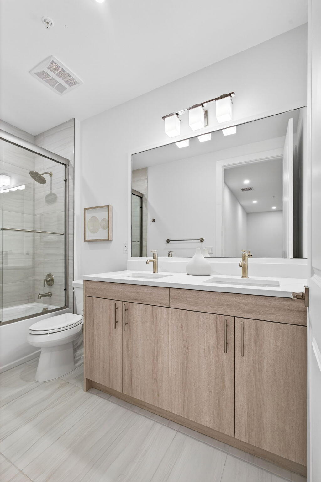 115 Water Pointe Place, Unit 35 Jupiter, FL 33477 - Photo 30 of 42 a bathroom with a double vanity sink mirror and toilet