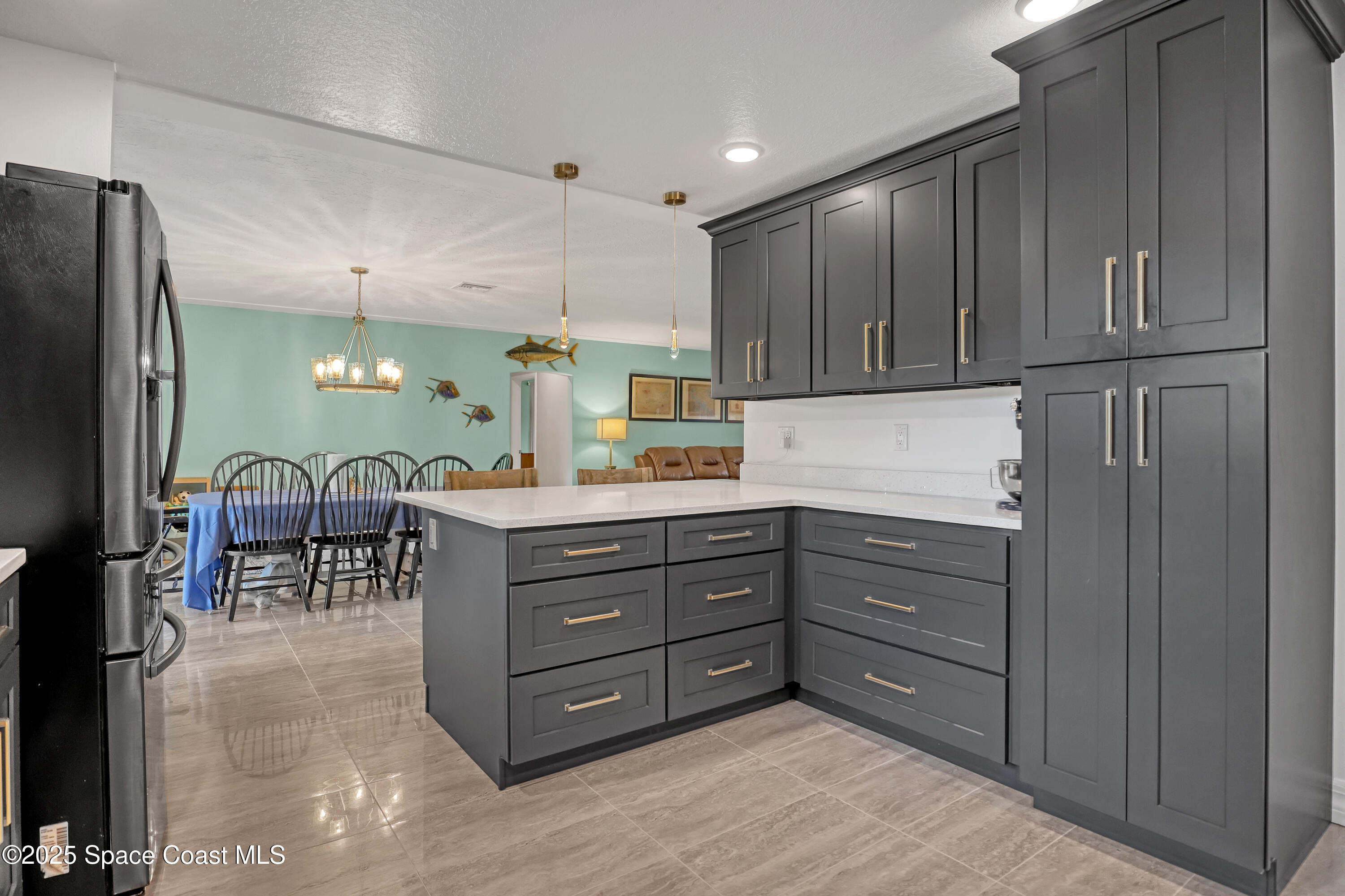 2307 Country Club Road Melbourne, FL 32901 - Photo 15 of 50 a kitchen with stainless steel appliances granite countertop a refrigerator and a cabinets