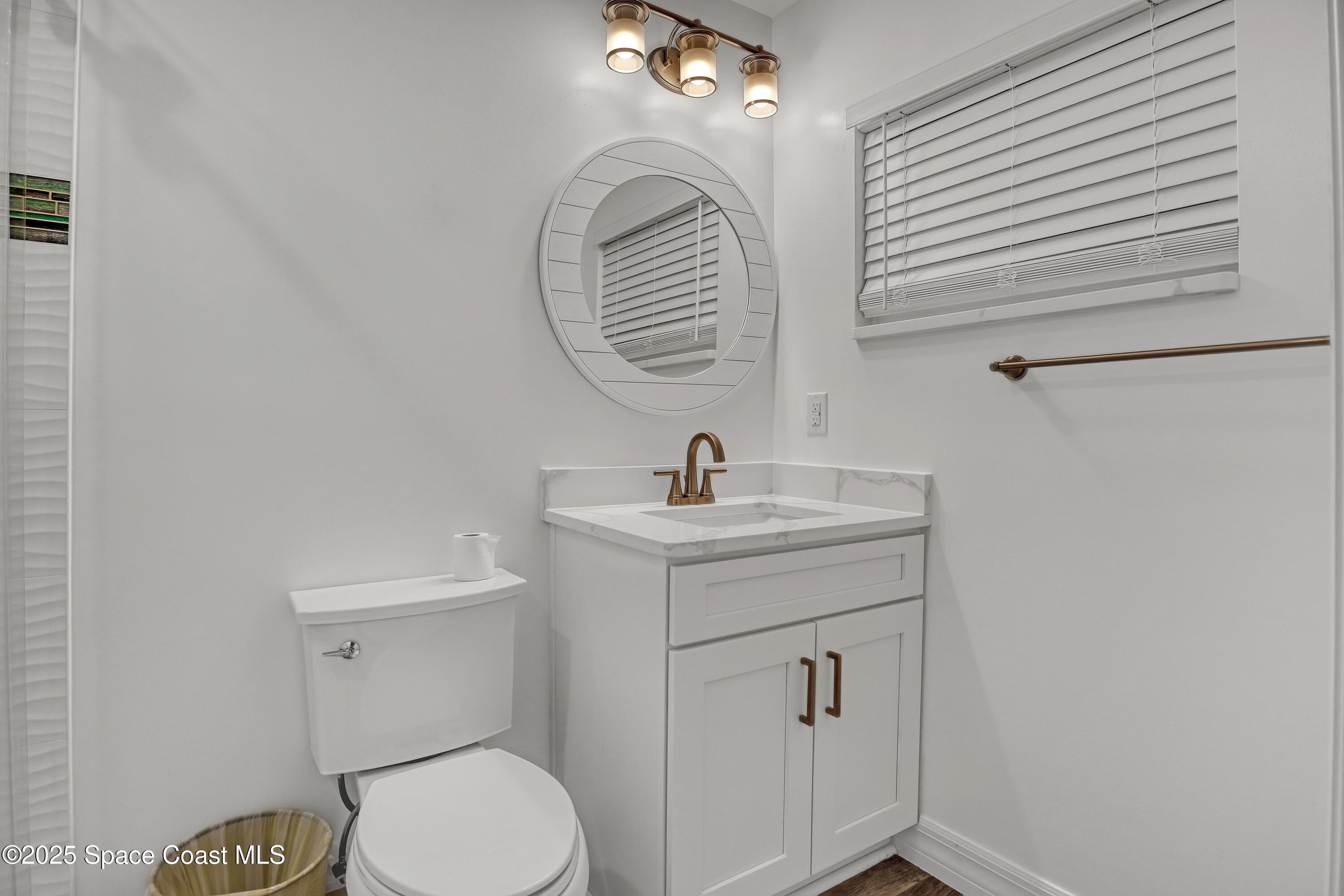 2307 Country Club Road Melbourne, FL 32901 - Photo 17 of 50 a bathroom with a toilet a sink and mirror