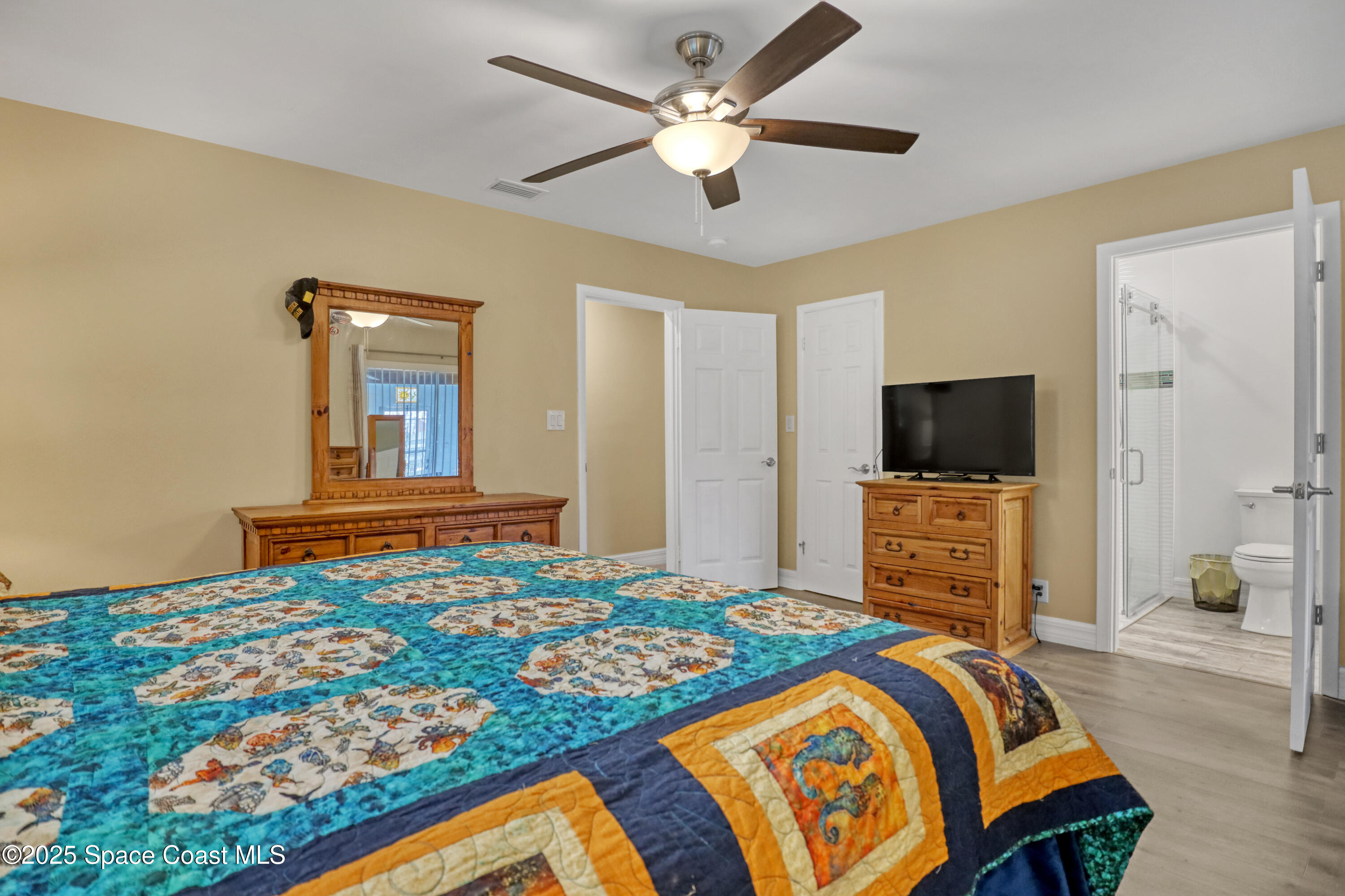2307 Country Club Road Melbourne, FL 32901 - Photo 19 of 50 a bedroom with a bed and a flat screen tv