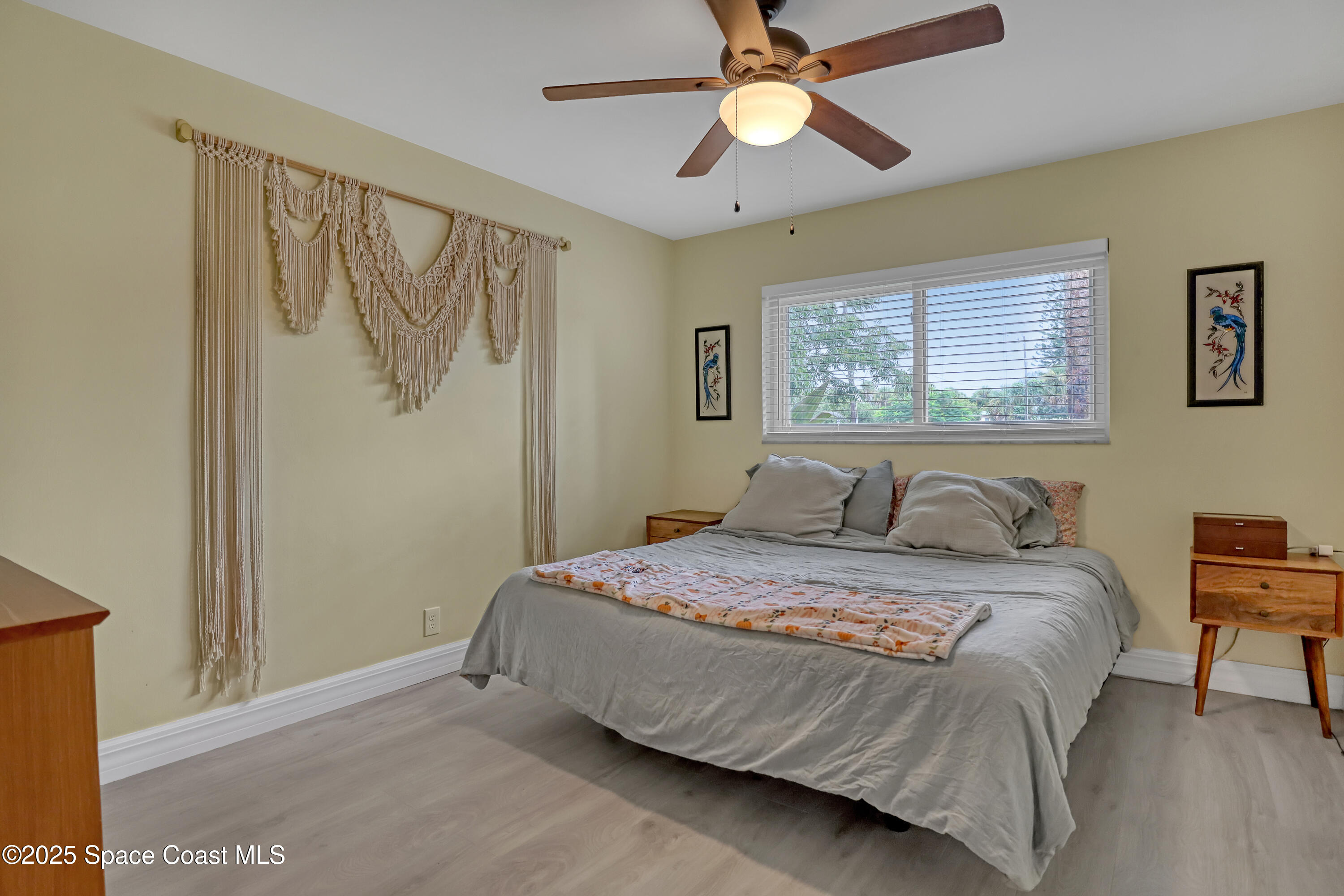2307 Country Club Road Melbourne, FL 32901 - Photo 22 of 50 a bedroom with a bed and a chandelier
