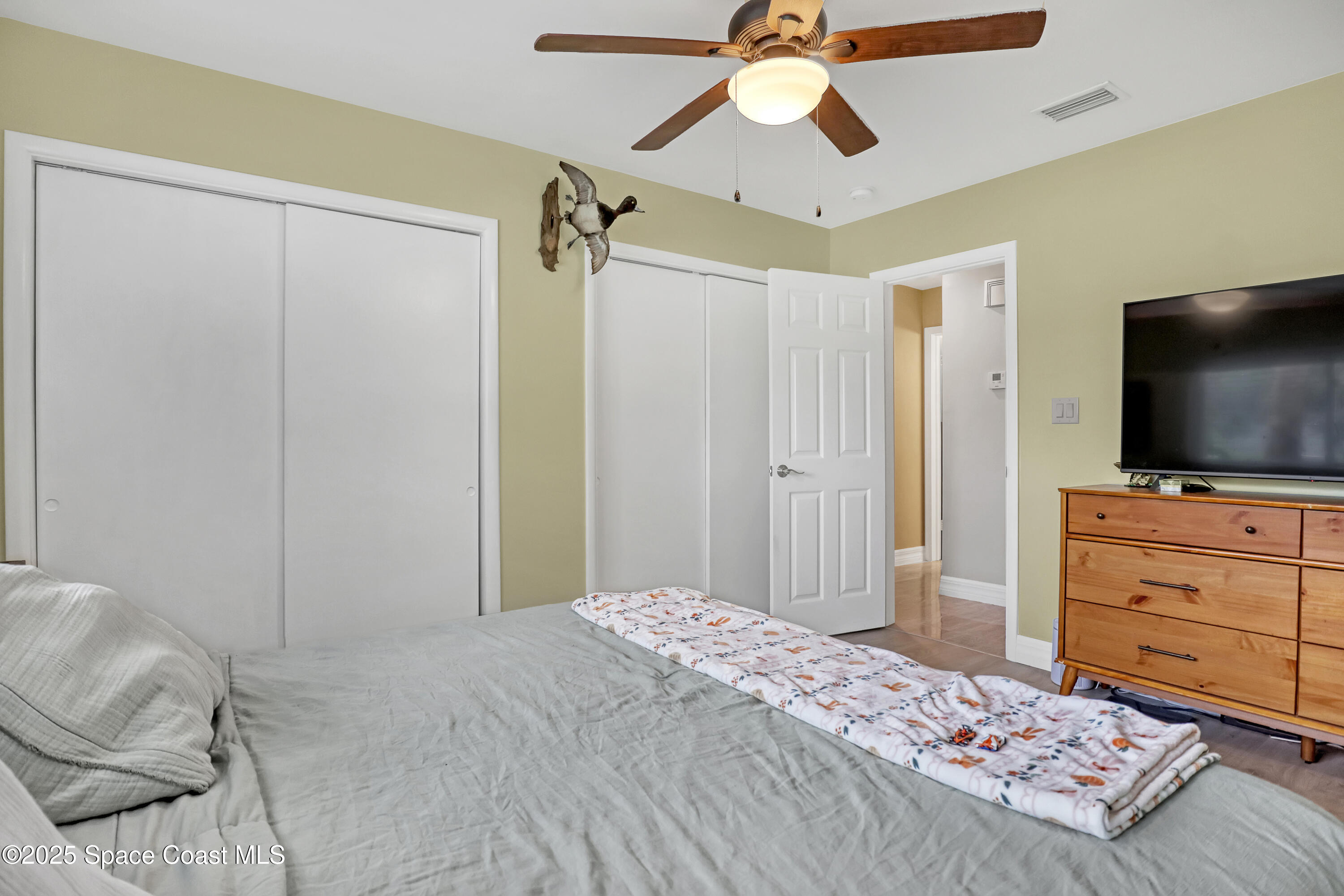 2307 Country Club Road Melbourne, FL 32901 - Photo 23 of 50 a bedroom with a bed and a flat screen tv