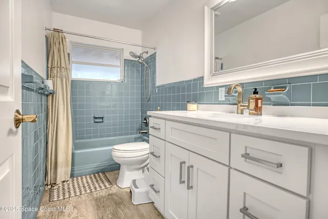 a living room with furniture and a large window with wooden floor