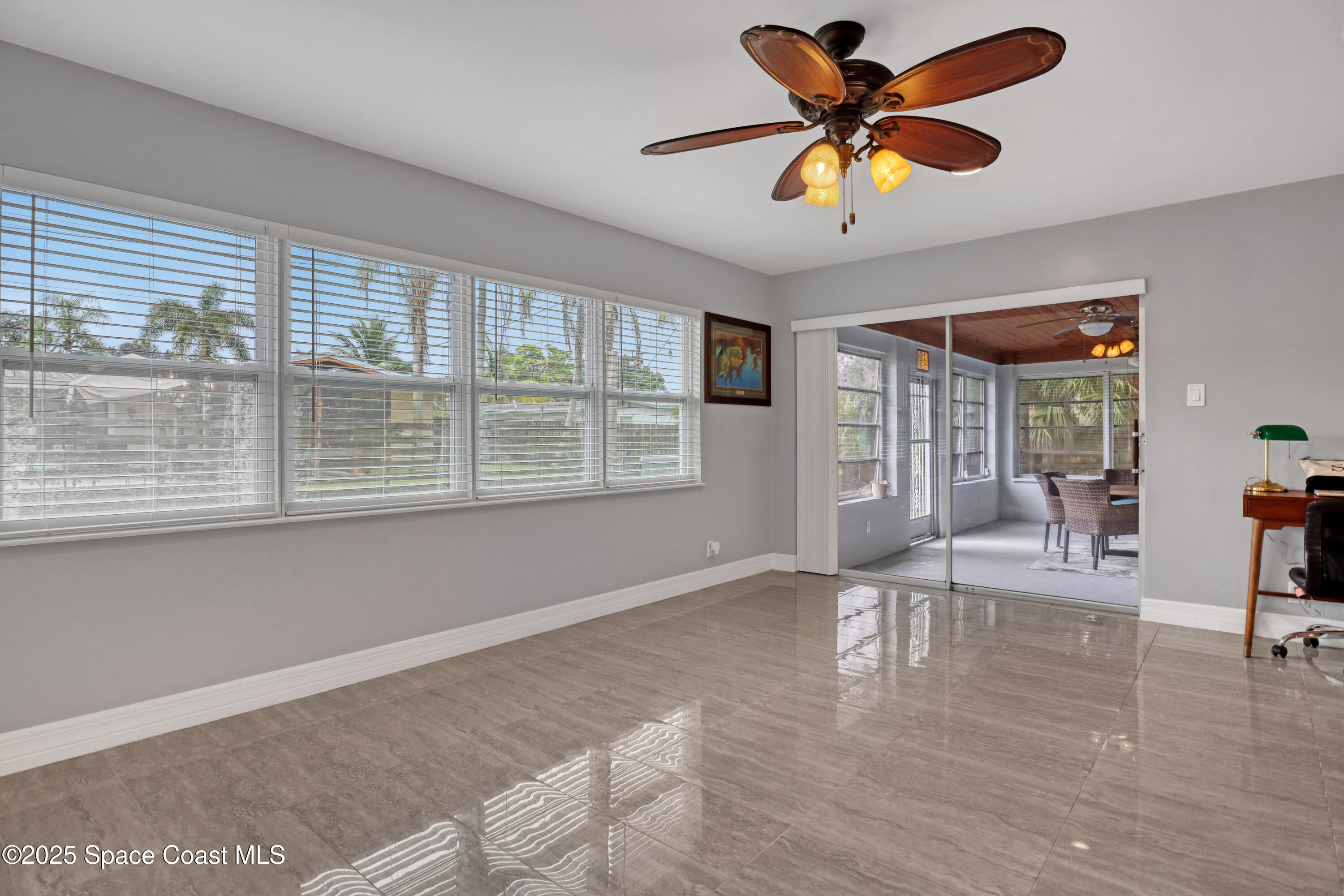 2307 Country Club Road Melbourne, FL 32901 - Photo 25 of 50 a living room with furniture and a large window with wooden floor