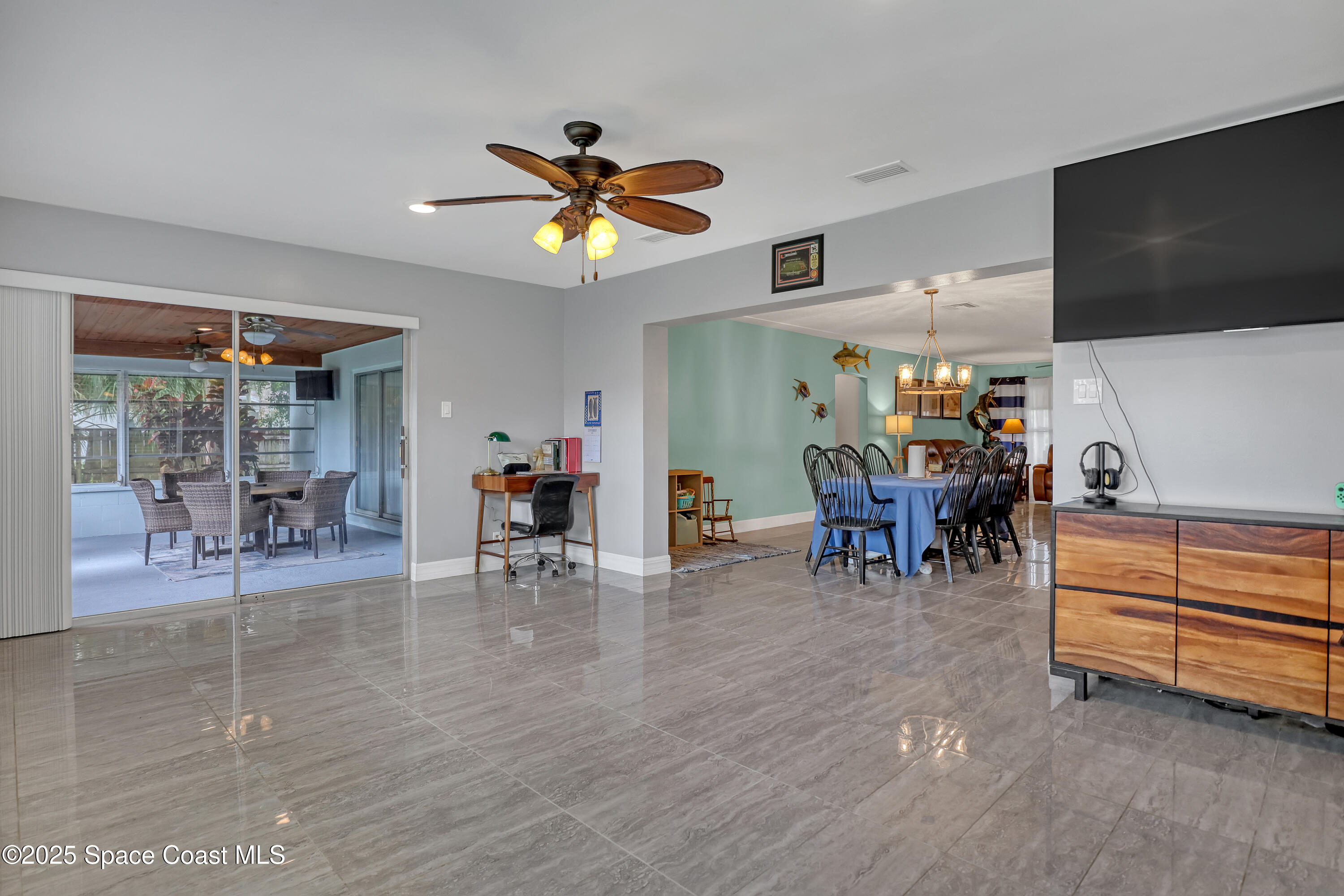 2307 Country Club Road Melbourne, FL 32901 - Photo 26 of 50 a view of a livingroom with furniture and a flat screen tv