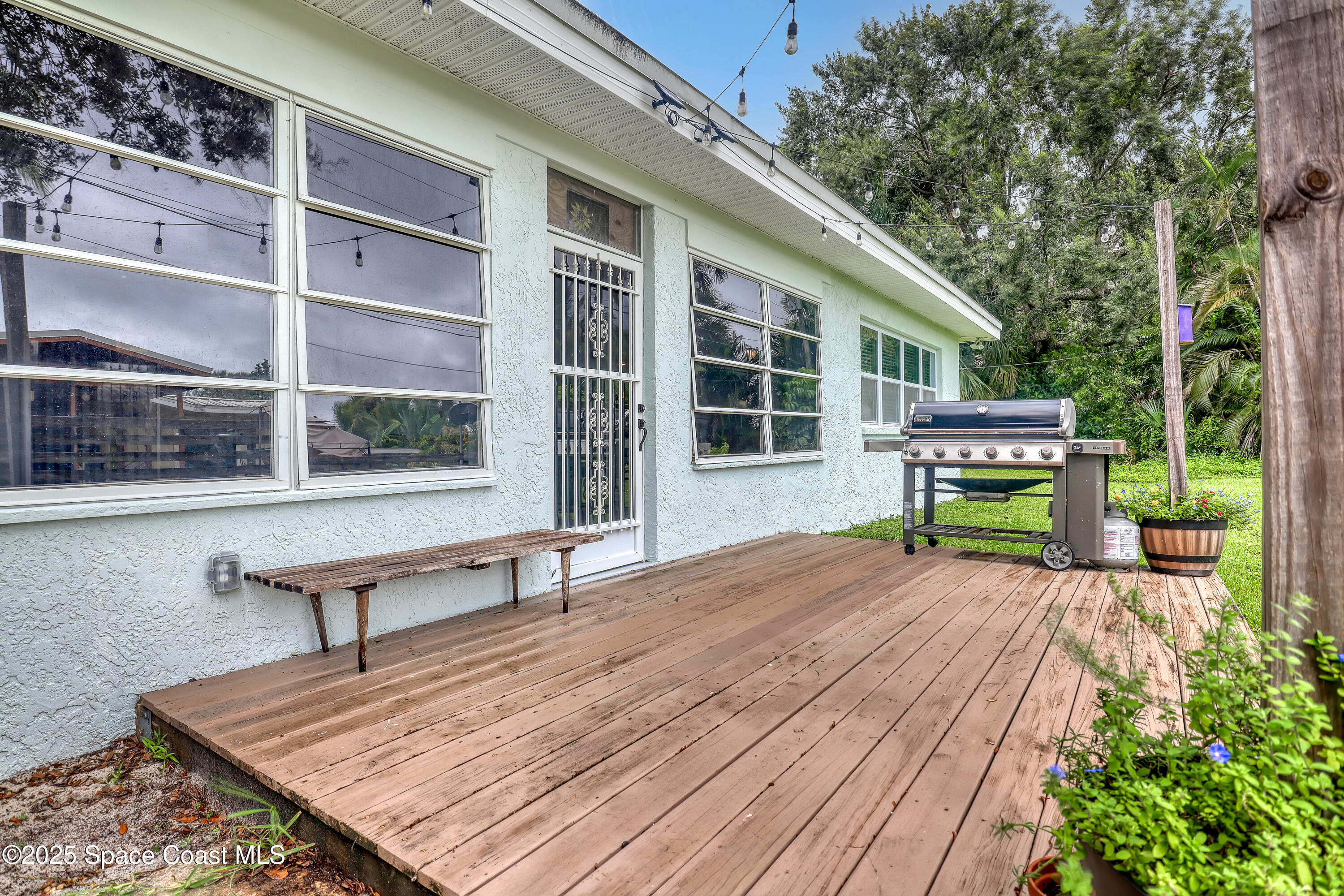 2307 Country Club Road Melbourne, FL 32901 - Photo 31 of 50 a wooden bench sitting in front of a house