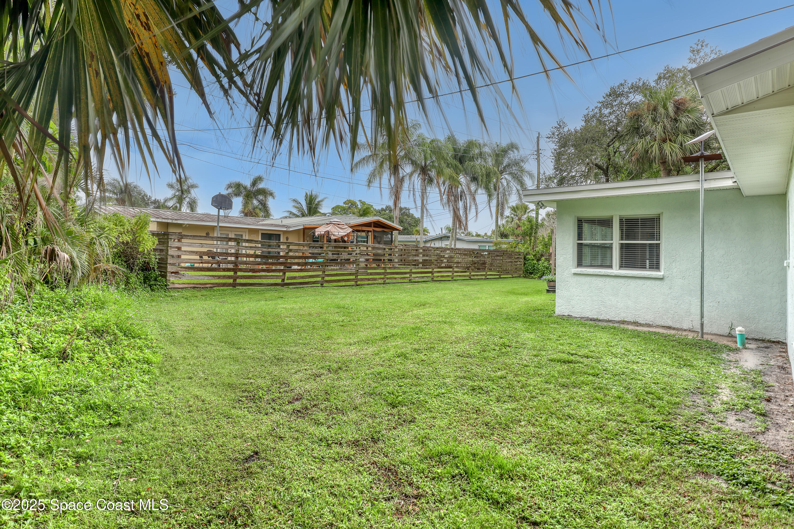 2307 Country Club Road Melbourne, FL 32901 - Photo 34 of 50 a view of a house with a yard and sitting area