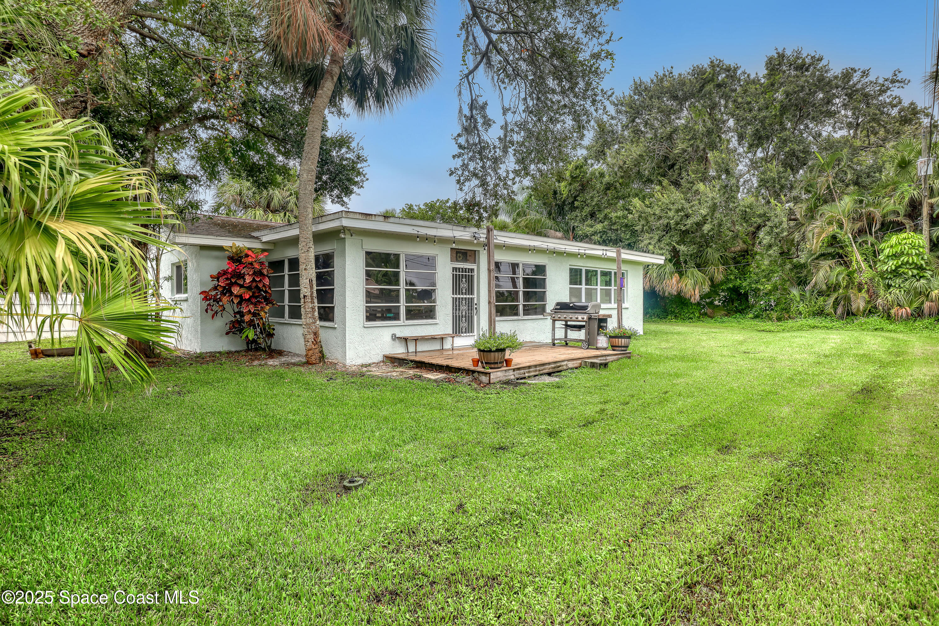 2307 Country Club Road Melbourne, FL 32901 - Photo 38 of 50 front view of a house with a yard table and chairs