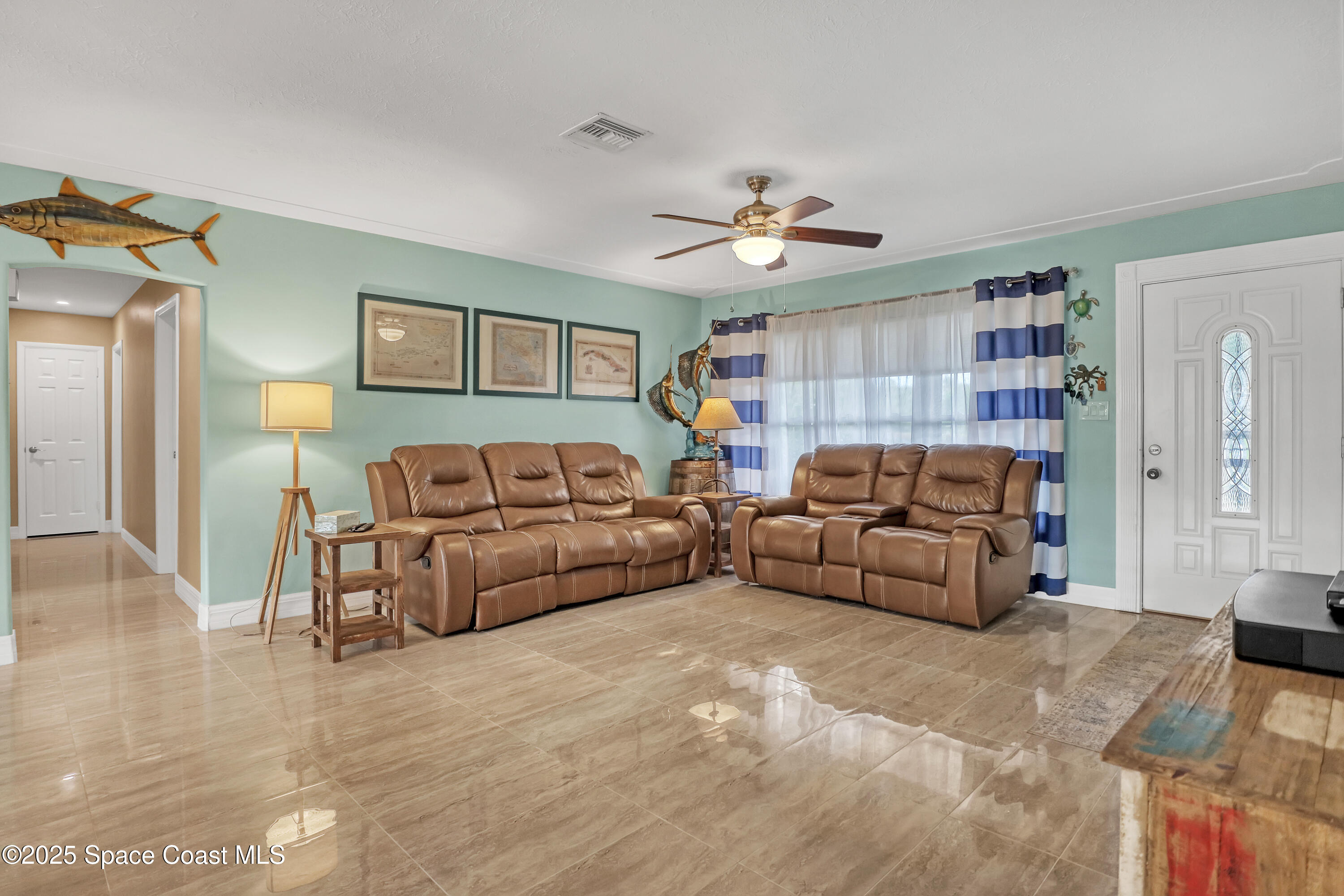 2307 Country Club Road Melbourne, FL 32901 - Photo 4 of 50 a living room with furniture and a ceiling fan