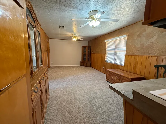 a kitchen with stainless steel appliances granite countertop a refrigerator a stove and a sink with cabinets